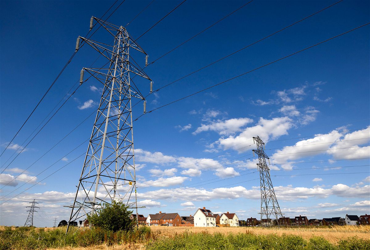 <i>Chris Ratcliffe/Bloomberg/Getty Images/FILE</i><br/>Electricity transmission towers are pictured near a new residential housing estate in Rayleigh