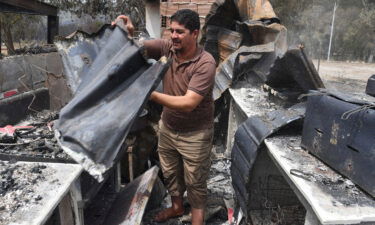 At least 26 people have been killed and several injured in wildfires that ravaged mountainous areas in the east of Algeria. A man checks burnt objects following raging fires in Algeria's city of el-Kala on August 17.