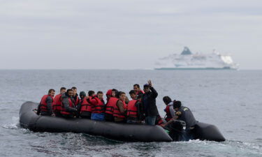 An inflatable craft carrying migrants crosses the shipping lane in the English Channel on August 4 off the coast of Dover