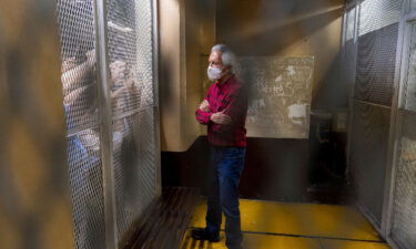 Award-winning journalist Jose Ruben Zamora stands inside a cell after a court hearing in Guatemala City on July 30.