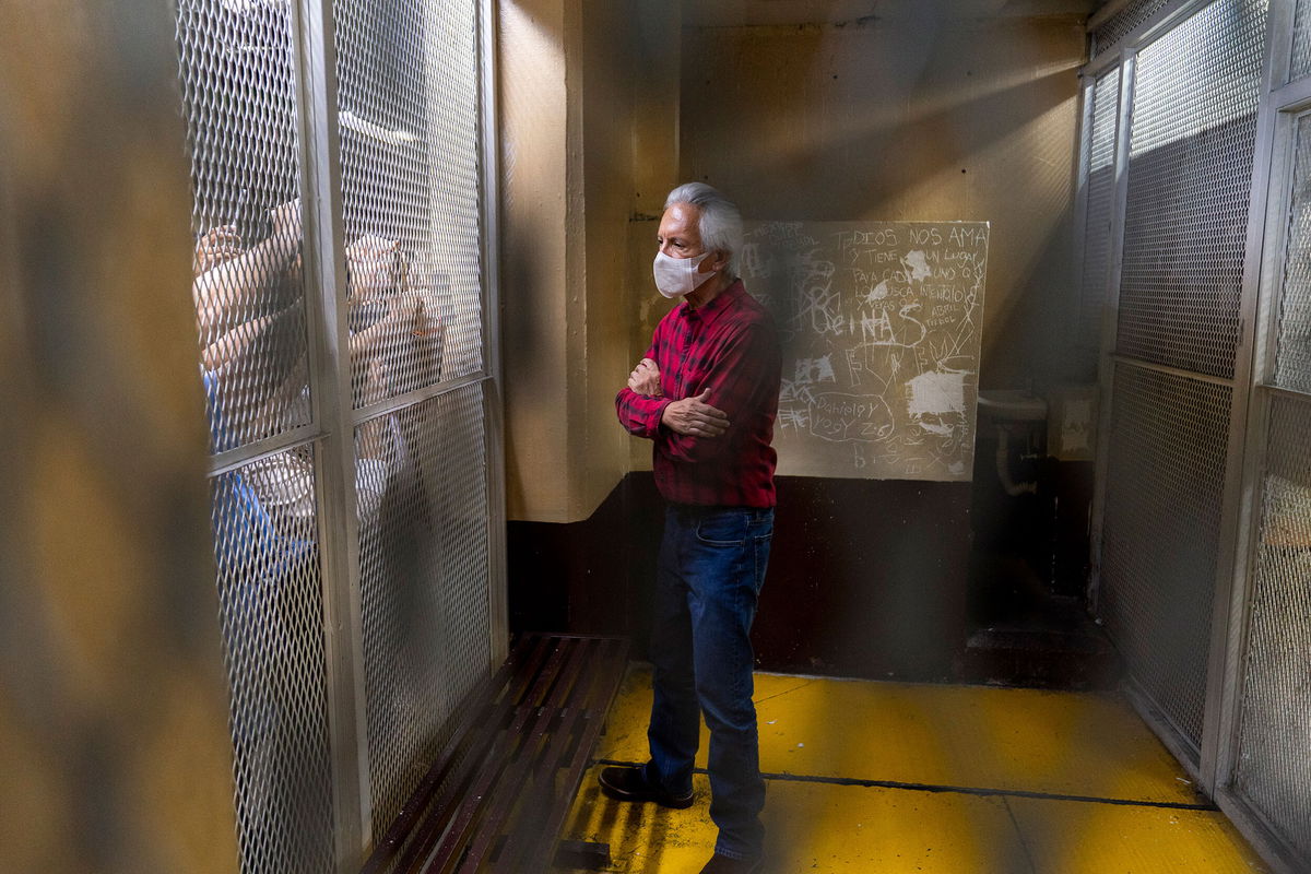 <i>Moises Castillo/AP</i><br/>Award-winning journalist Jose Ruben Zamora stands inside a cell after a court hearing in Guatemala City on July 30.