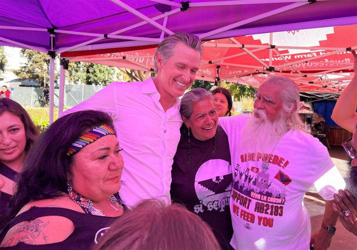 Governor Newsom signs law expanding farmworker union rights alongside farmworkers at the State Capitol
