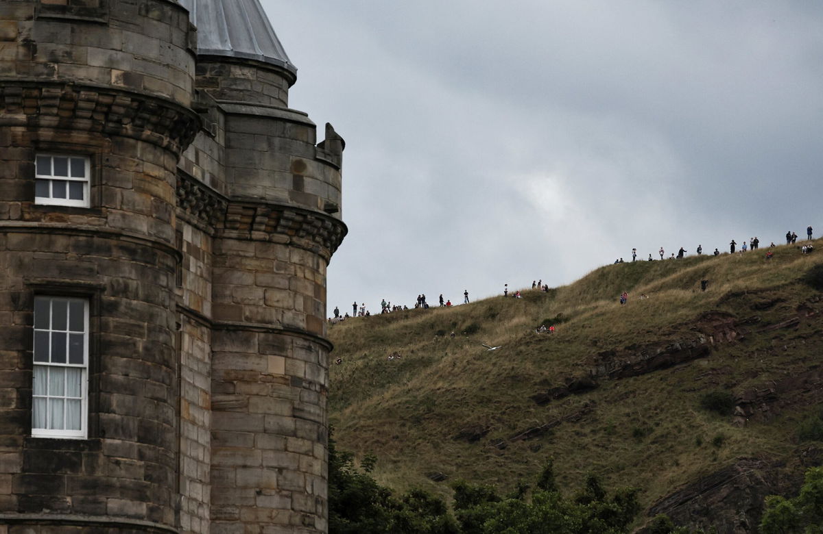 <i>Alkis Konstantinidis/Reuters</i><br/>People wait for the hearse's arrival in Edinburgh.