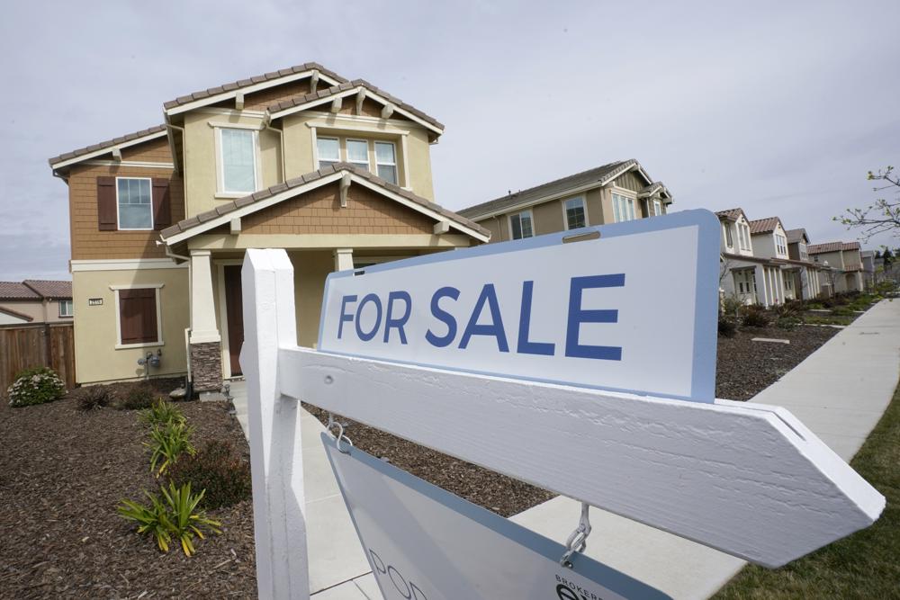 FILE - A for sale sign is posted in front of a home in Sacramento, Calif., Thursday, March 3, 2022. The Federal reserve is expected at its meeting this week to raise its key interest rate by a substantial three-quarters of a point for the third consecutive time. Another hike that large would lift its benchmark rate — which affects many consumer and business loans — to a range of 3% to 3.25%, the highest level in 14 years.