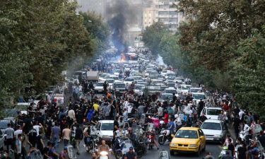 Dozens of people stage a demonstration to protest the death of a 22-year-old woman under custody in Tehran on September 21.