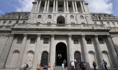 People wait at the Bank of England in London on August 4.