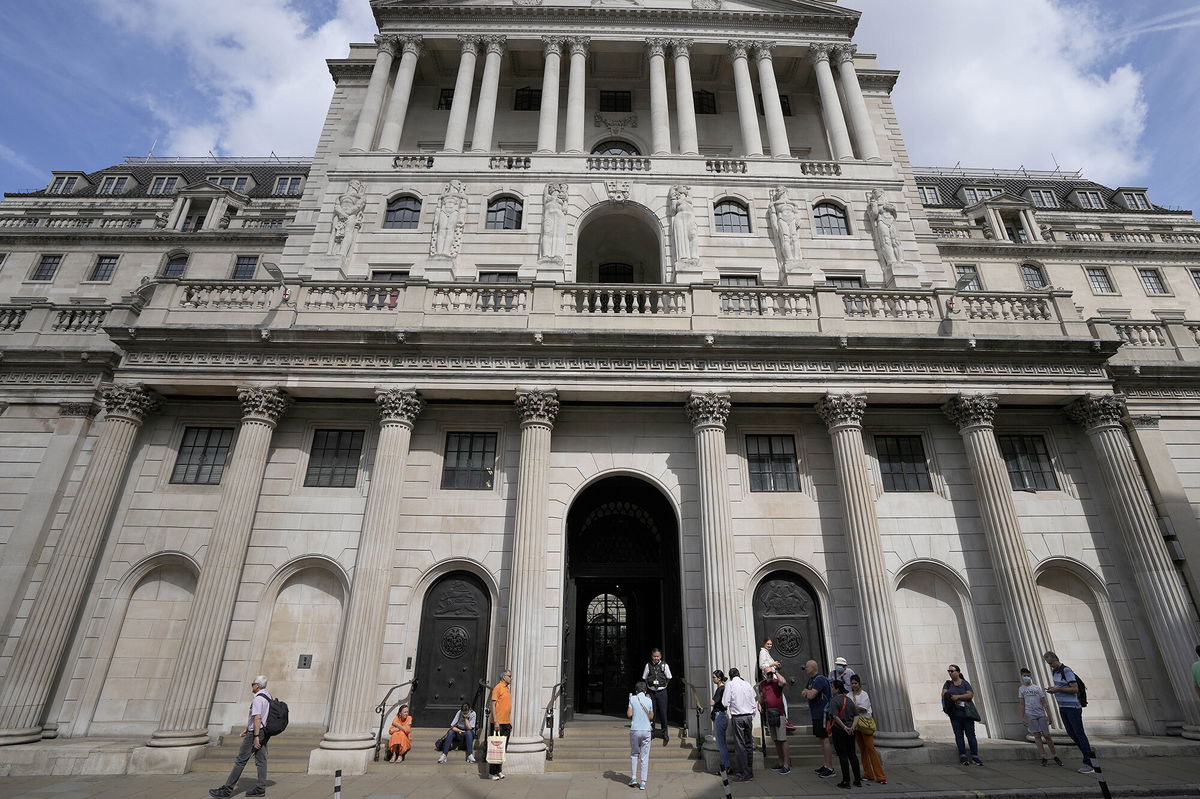 <i>Frank Augstein/AP</i><br/>People wait at the Bank of England in London on August 4.