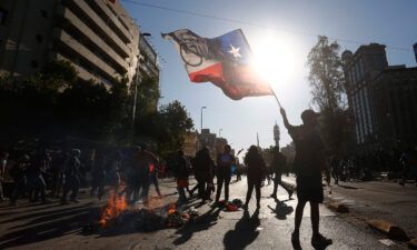 A demonstrator waves the Chilean flag during a November 2020 protest against then President Sebastian Pinera in Santiago.