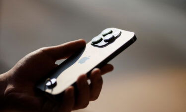 Apple has started making its new iPhone 14 in India. A man holds an iPhone 14 as Apple Inc's new models go on sale at an Apple store in Beijing