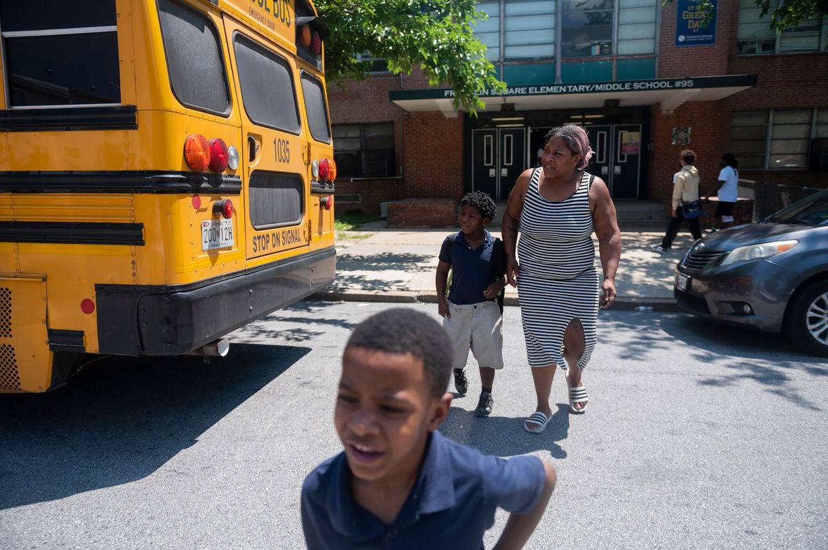 <i>Vincent Alban/The Baltimore Sun/AP</i><br/>Latoya Carroll picks up her children from early dismissal at Baltimore's Franklin Square Elementary/Middle School in May due to a lack of air conditioning.