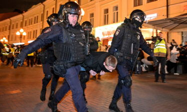 Police officers detain a man in Moscow amid protests against Putin's mobilization of citizens.