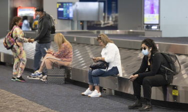 Travelers wait at LaGuardia Airport in the Queens borough of New York on July 1.