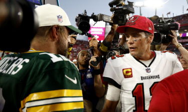 Aaron Rodgers (left) and Tom Brady greet each other after Sunday's game.