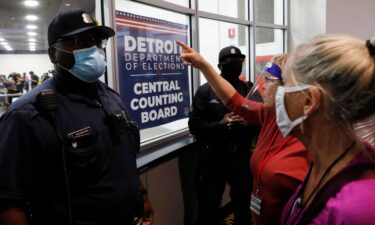 Police officers are seen outside the room where absentee ballots for the 2020 general election were counted on November 4