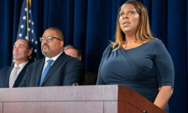 New York State Attorney General Letitia James (right) speaks as Manhattan District Attorney Alvin Bragg looks on during a press conference after Steve Bannon surrendered at the NY District Attorney's office to face charges on September 8 in New York City.