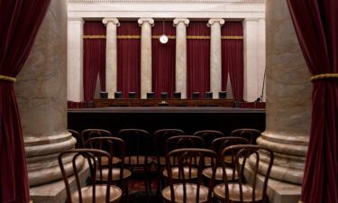 Chairs of U.S. Supreme Court justices sit behind the courtroom bench in Washington