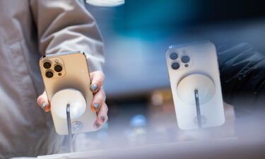 A customer views an Apple iPhone 13 Pro Max smartphone for sale at a store in New York