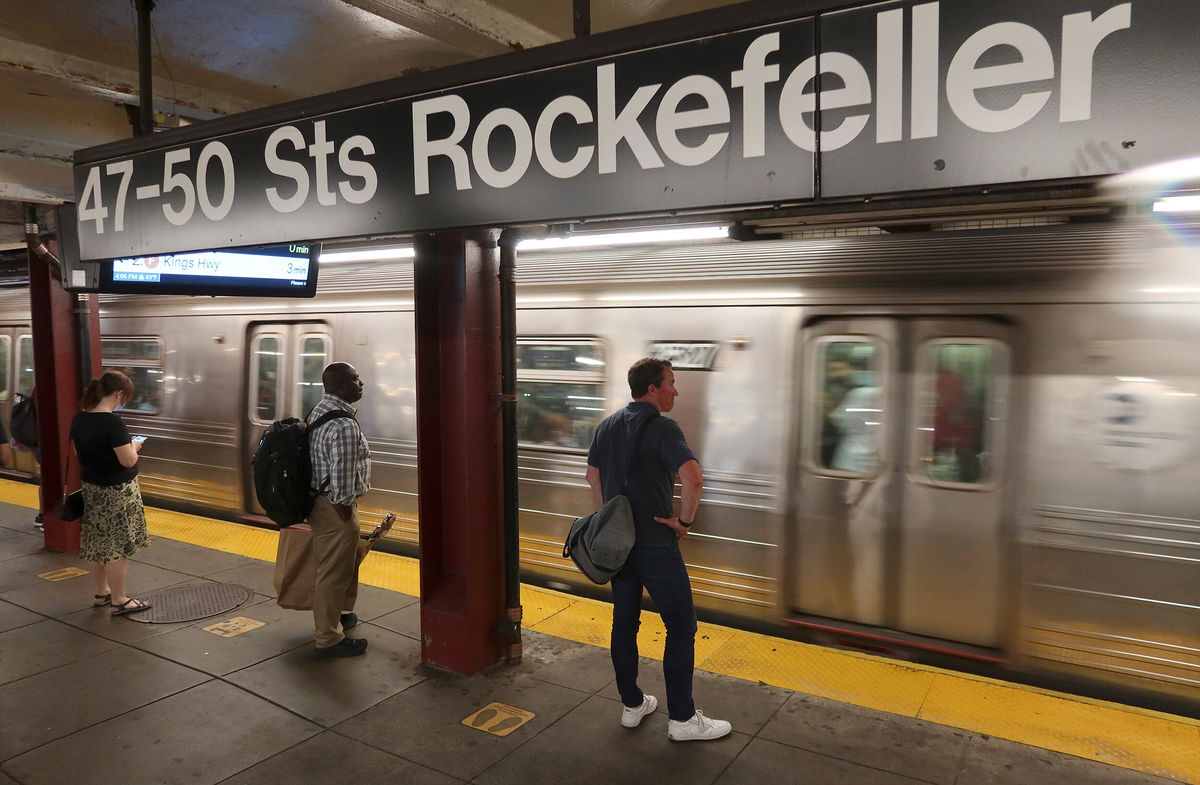 <i>Gary Hershorn/Getty Images/FILE</i><br/>People wait to board a train at the 47 -50 Sts - Rockefeller Center subway station on July 15 in New York City. New York City faces a potential fiscal cliff with a nearly $10 billion deficit by 2026.