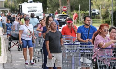 Shoppers wait in line on September 25 as people rush to prepare for Hurricane Ian in Kissimmee