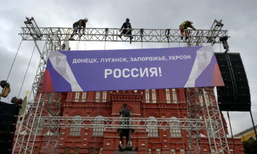 The US is imposing "swift and severe costs" on Russia after President Vladimir Putin announced the annexation of regions of Ukraine. Workers fix a banner reading "Donetsk