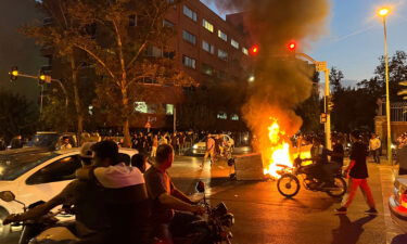 Five people have been killed by Iranian security forces during protests that were sparked by the death of Mahsa Amini. Demonstrators are pictured here gathering around a burning barricade during a protest for Amini.