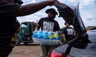 Residents distributed cases of water in Jackson earlier this month.