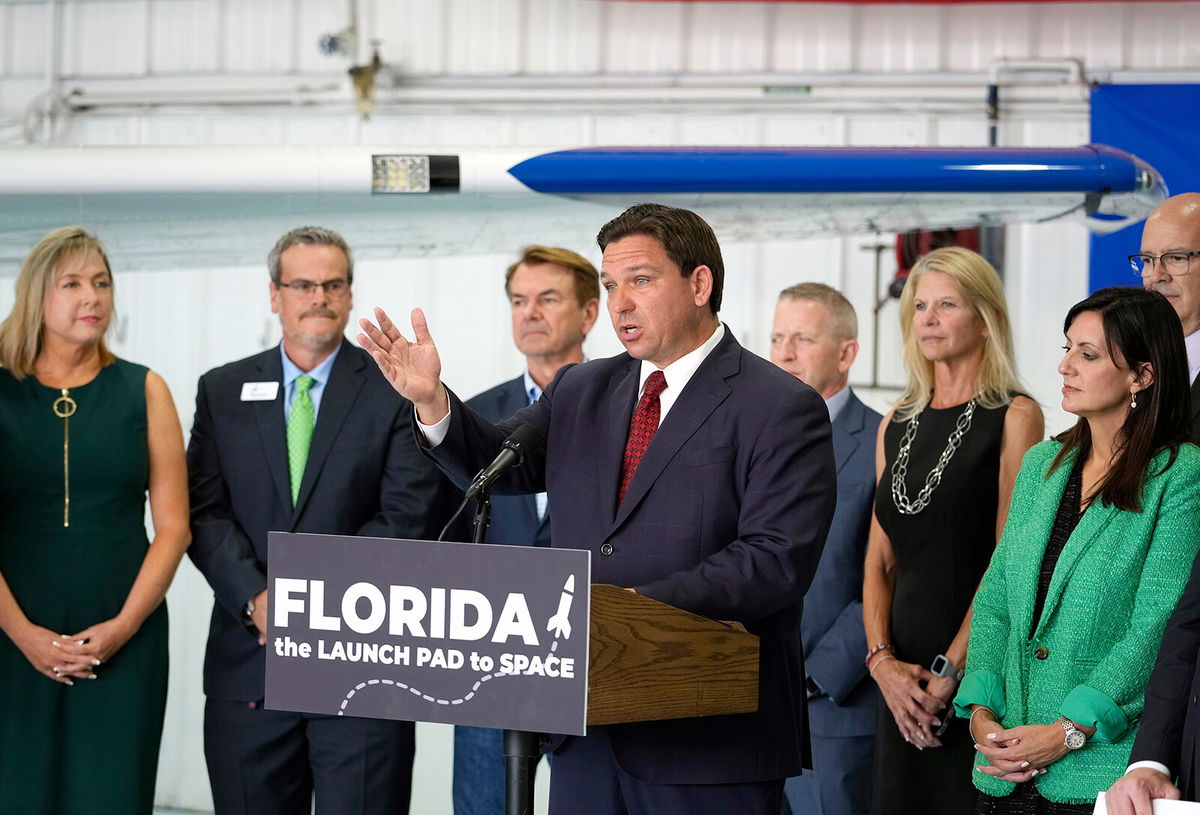<i>Nigel Cook/AP</i><br/>Gov. Ron DeSantis (center) holds a news conference at Embry-Riddle Aeronautical University in Daytona Beach on September 16.