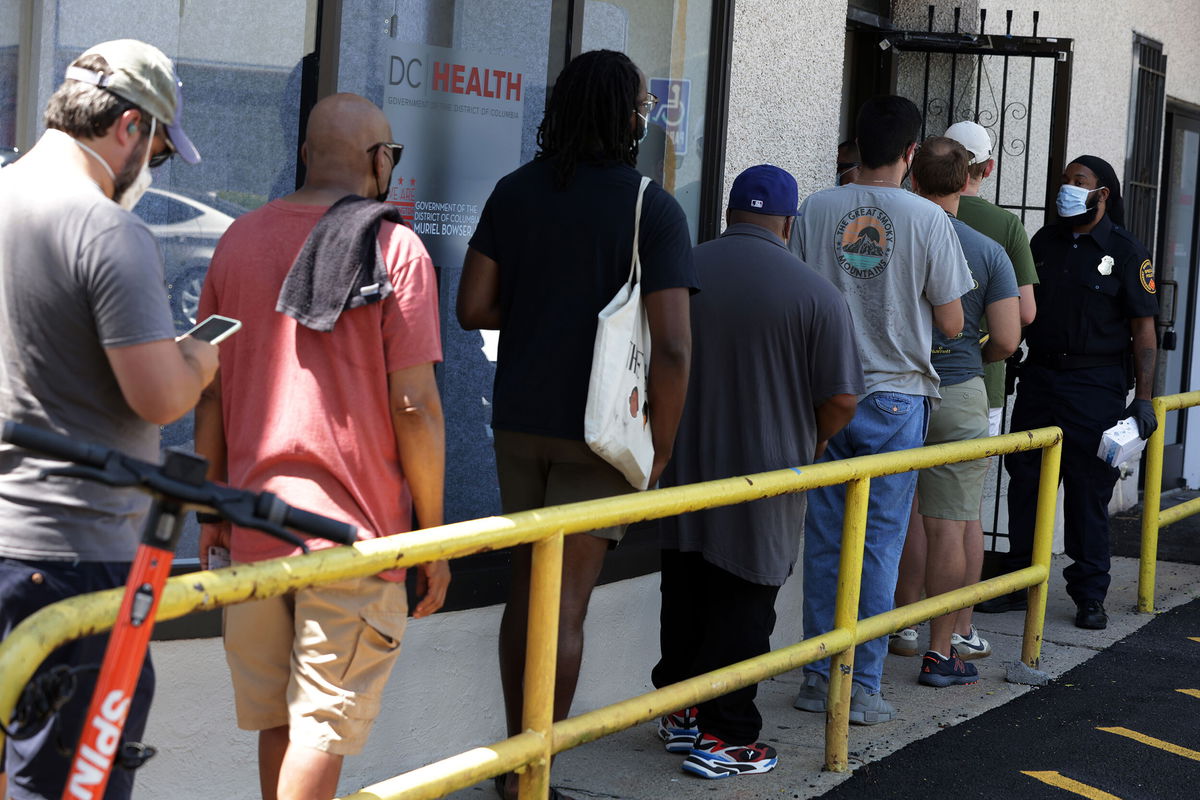 <i>Alex Wong/Getty Images</i><br/>Residents wait in line at a DC Health location administering the monkeypox vaccine on August 5