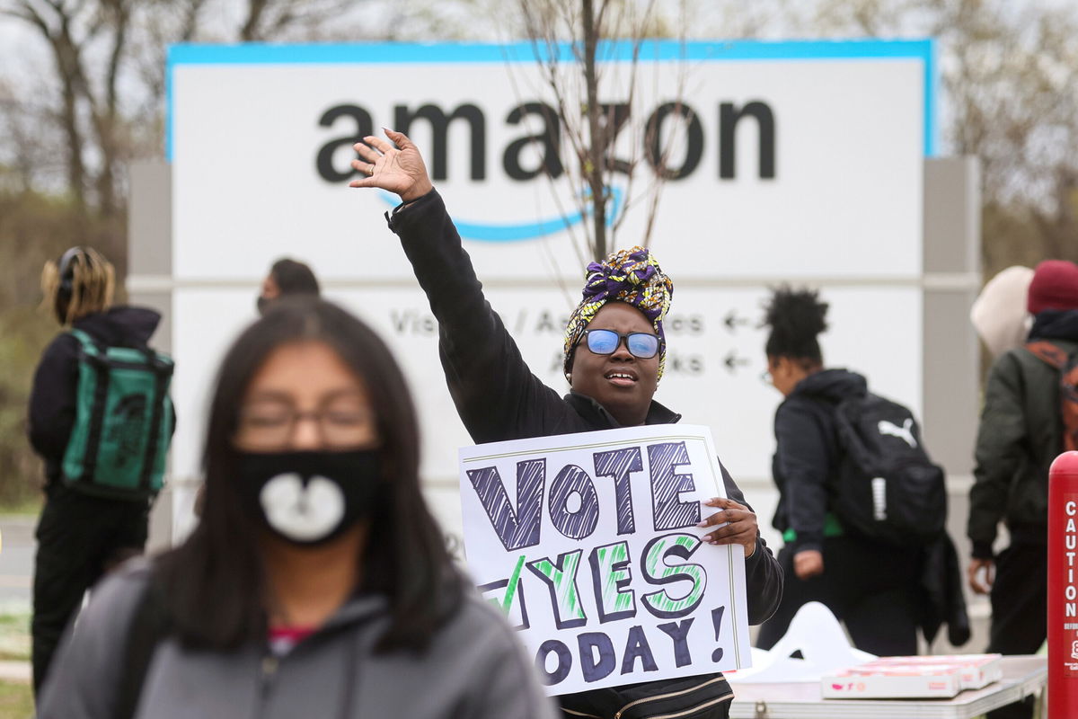 <i>Brendan McDermid/Reuters</i><br/>Amazon has lost the first round in its effort to overturn a historic union victory at a Staten Island facility. An Amazon Labor Union organizer greets workers outside an Amazon sortation center in Staten Island on April 25.