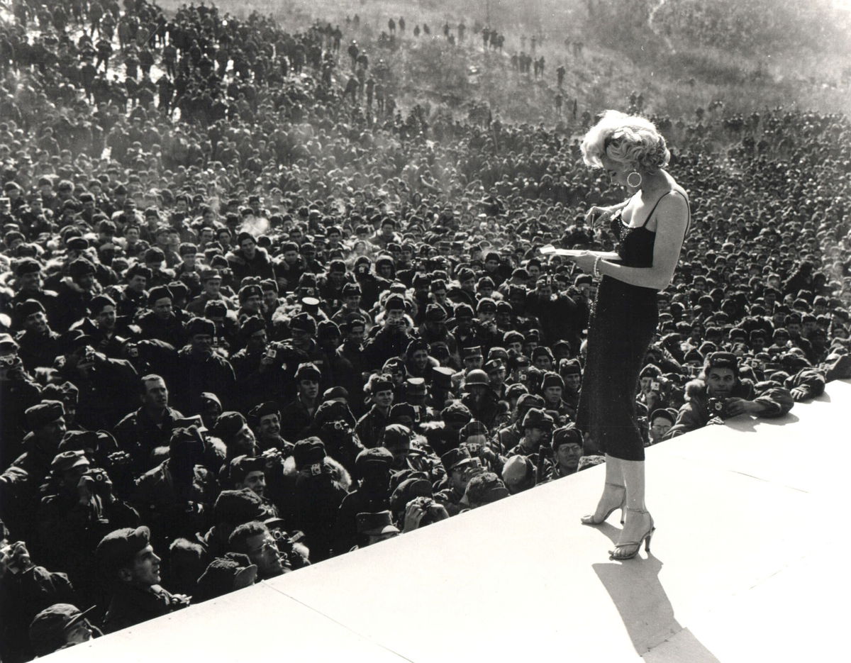 <i>Greg Mathieson/Getty Images</i><br/>Marilyn Monroe signs an autograph for a US serviceman in Korea as part of the USO program.