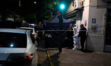 Police work behind a security cordon after a man pointed a gun at Argentine Vice-President Cristina Fernandez de Kirchner outside her residence in Buenos Aires on September 1.