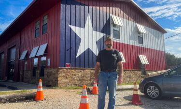 Phil Waldron poses for a photo at his distillery