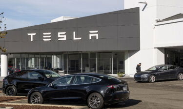 A customer looks at a vehicle at a Tesla dealership in Vallejo