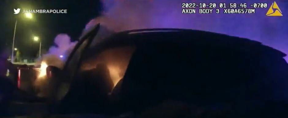 <i>Alhambra police/KABC</i><br/>Incredible video shows the moment Alhambra police officers pulled an injured driver from a burning vehicle after it crashed.