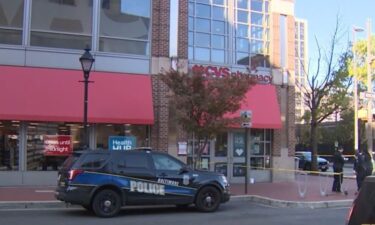 A security guard shot a syringe-wielding theft suspect in the face at a store in Harbor East