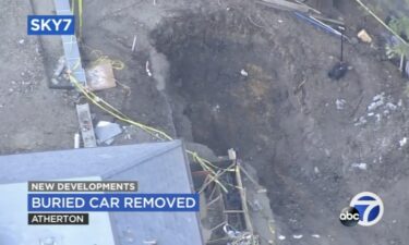 Investigators say they have removed a car that was found earlier this week buried in the backyard of a multi-million dollar mansion in Atherton.