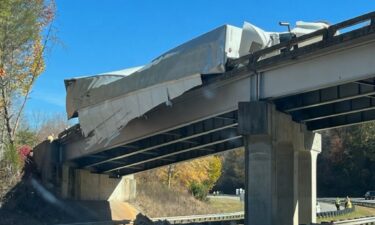 Jackson County Emergency Management says crews responded to a crash involving a tractor trailer on the on ramp at exit 85 of US 74. Westbound lanes were closed off due to the crash. Part of the truck's trailer could be seen hanging off of the overpass.