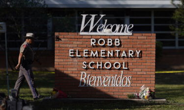 An officer walks outside Robb Elementary School in Uvalde