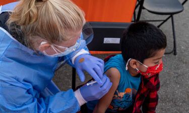 A health care worker administers a Pfizer/BioNTech Covid-19 vaccine to a child at a vaccination site in San Francisco on January 10.