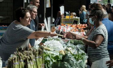 Customers shop for produce at the Eastern Market in Detroit