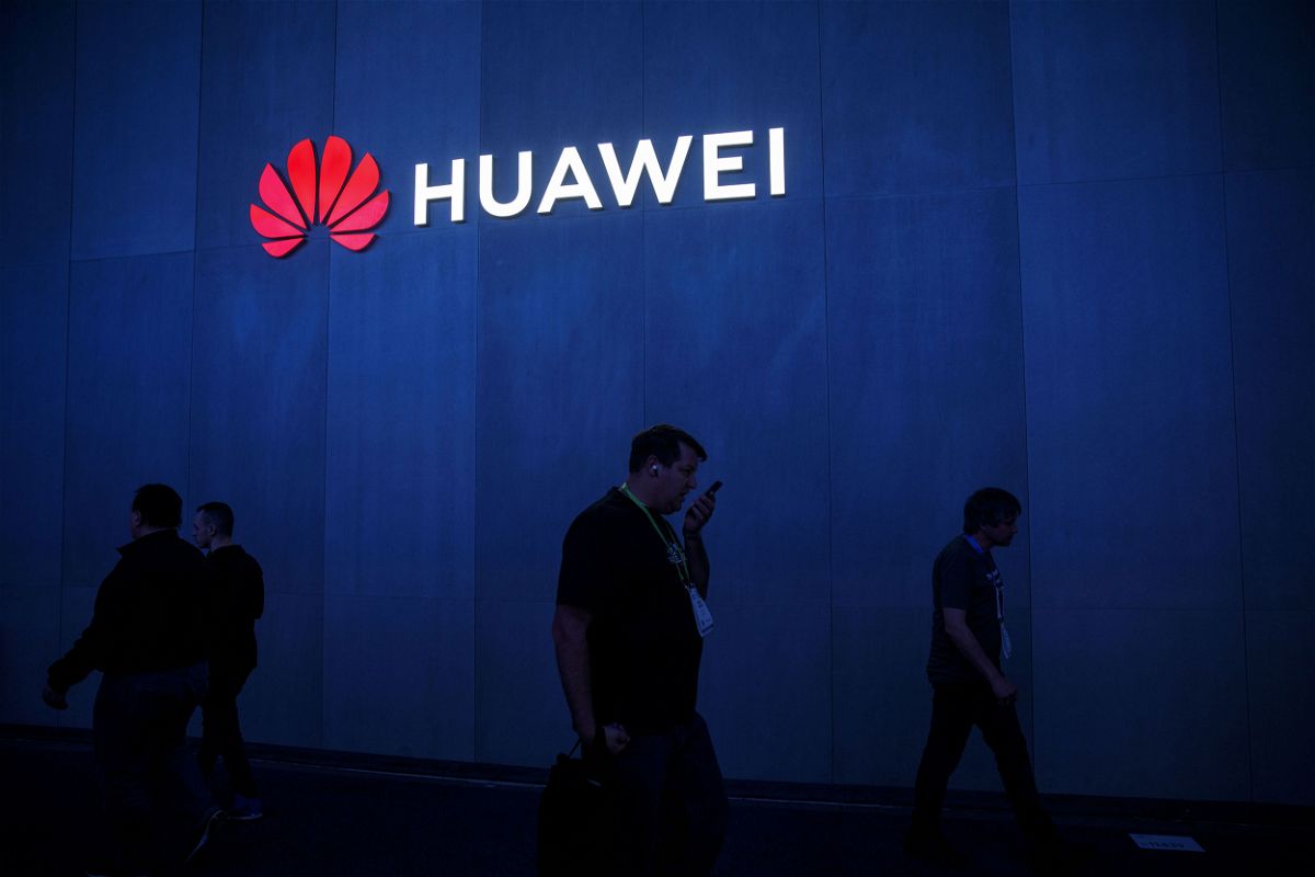 Attendees walk past signage displayed outside the Huawei Technologies Co. booth at the 2019 Consumer Electronics Show (CES) in Las Vegas, Nevada, U.S., on Wednesday, Jan. 9, 2019. Dozens of companies will give presentations at the event, where attendance is expected to top 180,000, with the trade war between the U.S. and China as well as Apple's sales woes looming over the gathering. Photographer: Patrick T. Fallon/Bloomberg via Getty Images