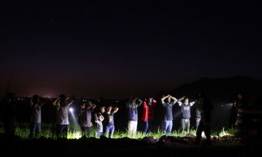 Migrants are detained by U.S. Border Patrol agents on May 22 in Yuma