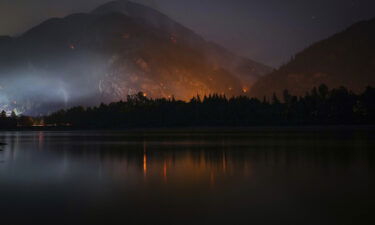 The Flood Falls Trail wildfire burns above the Fraser River in Hope