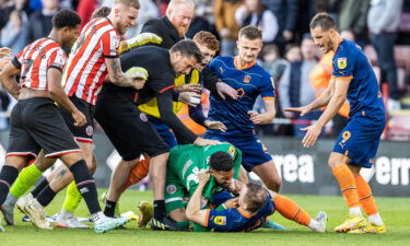 Blackpool's Shayne Lavery is taken to ground by Sheffield United's goalkeeper Wes Foderingham.