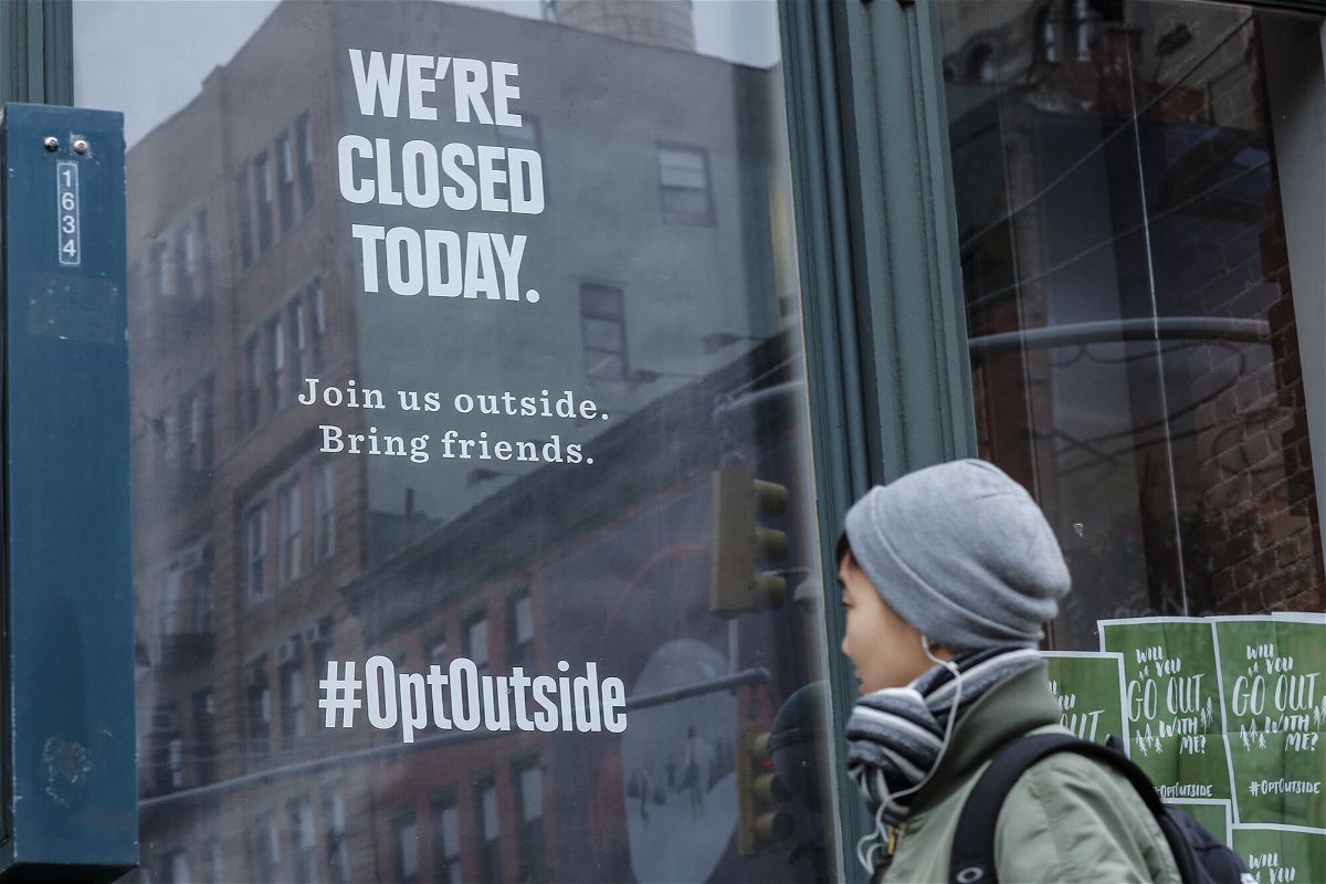 <i>Kena Betancur/AFP/Getty Images</i><br/>A woman walks past a closed REI store in New York on Black Friday