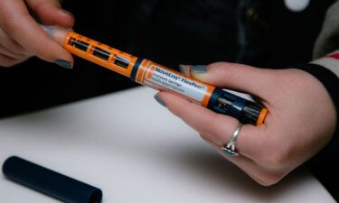 A person fastens a Becton Dickinson And Co. (BD) needle on a Novo Nordisk Inc. NovoLog brand insulin pen in New York in April 2019. A new study found that 1.3 million Americans with diabetes rationed insulin in the past year.