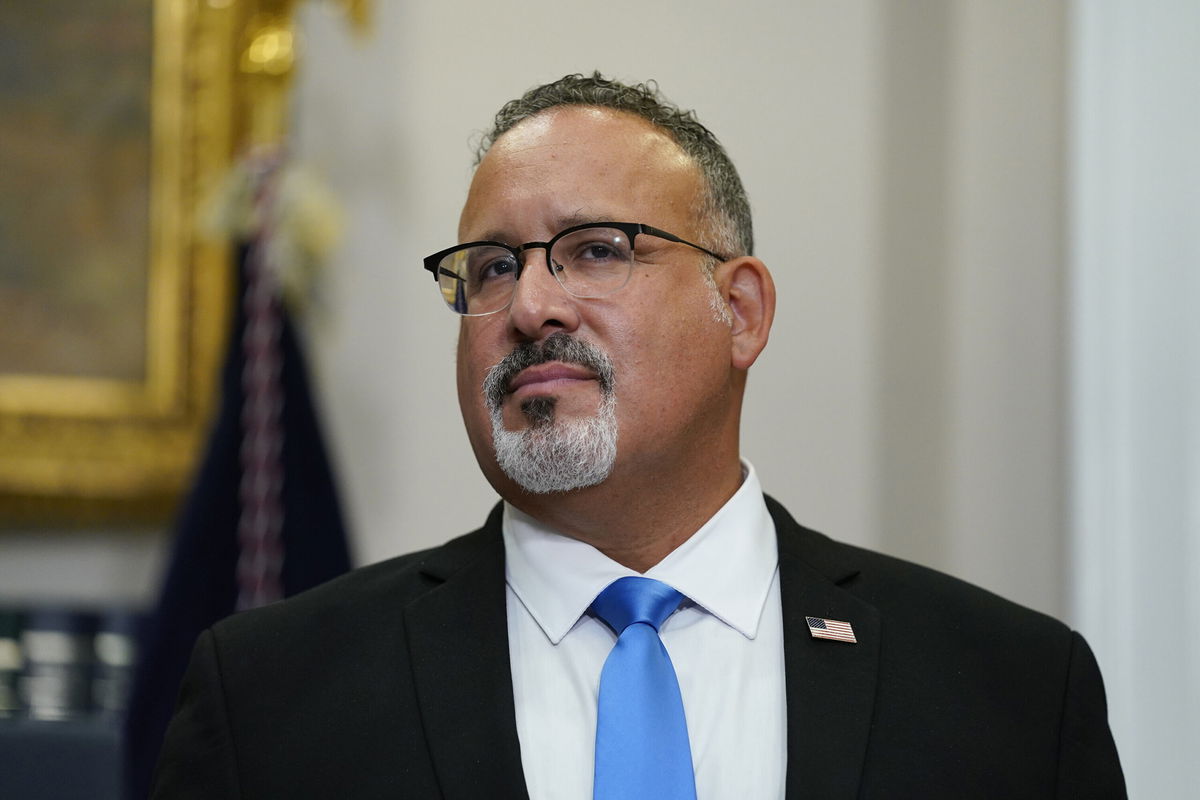 <i>Evan Vucci/AP</i><br/>Education Secretary Miguel Cardona listens as President Joe Biden speaks about student loan debt forgiveness at the White House on August 24.