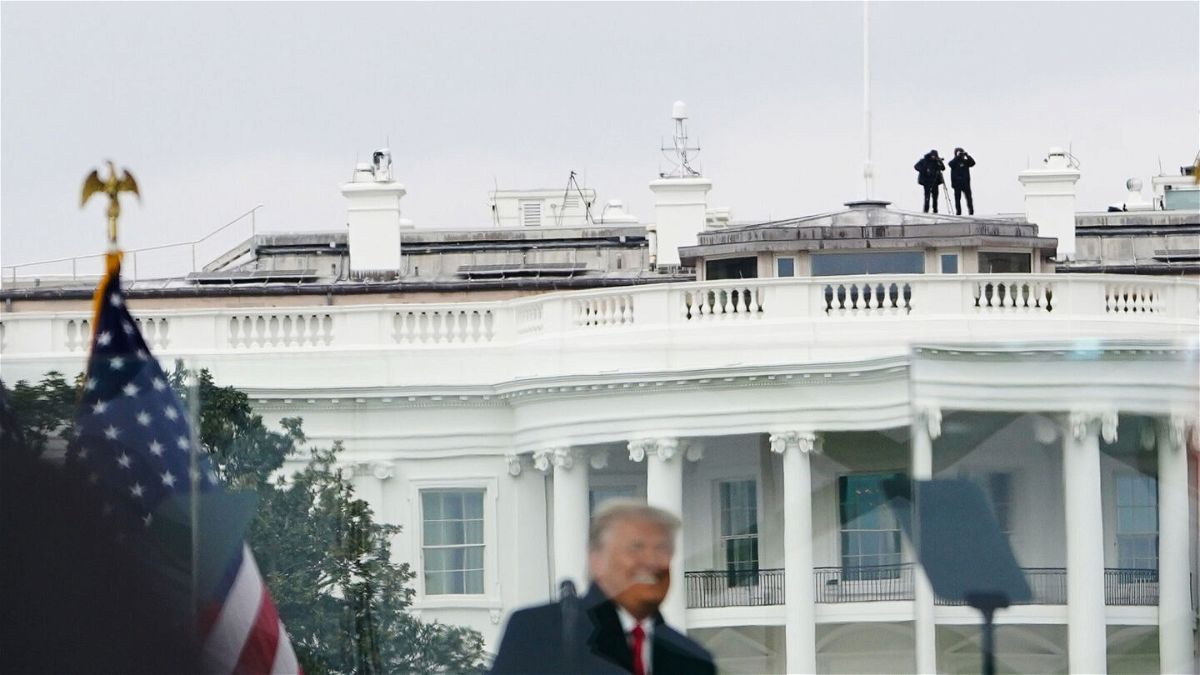 <i>MANDEL NGAN/AFP via Getty Images</i><br/>Members of the Secret Service patrol from the roof of the White House as former President Donald Trump speaks on January 6
