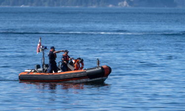 Federal investigators are asking the manufacturer of a seaplane that plunged into a Washington state bay to mandate inspections of the plane's tail section. A U.S. Coast Guard boat is seen here searching near Whidbey Island