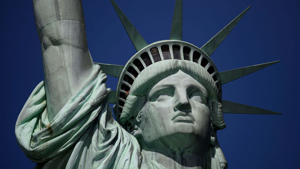 <i>JOHANNES EISELE/AFP via Getty Images</i><br/>A tourist's hand is seen at the crown of the Statue of Liberty in February 2019 in New York City. The public can once again enter the crown portion of the Statue of Liberty -- the first time since it closed its doors in March 2020.